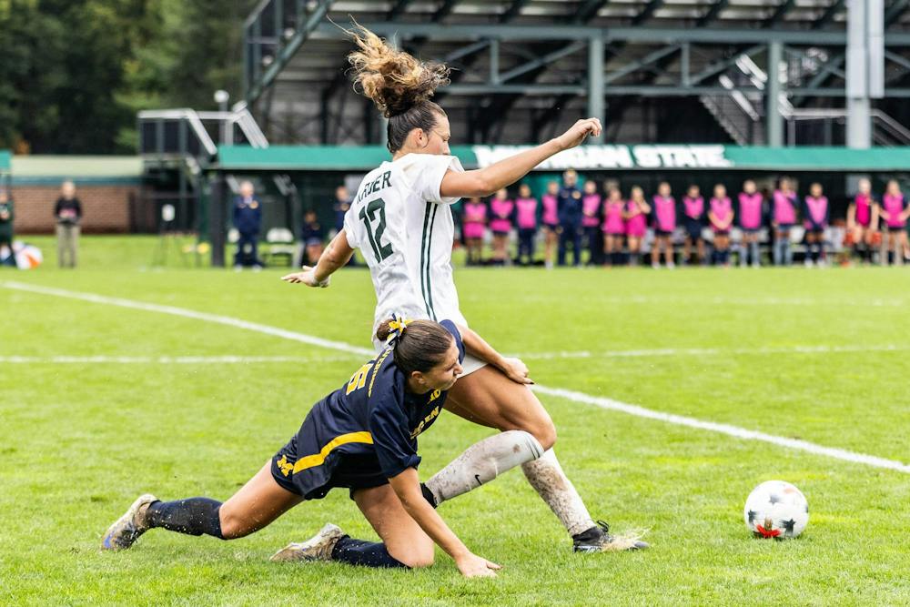 <p>Michigan State sophomore defender Mackenzie Kruer (12) is held back by Michigan defender late in the second half at DeMartin Stadium in East Lansing, Mich., on Sept. 20, 2026.</p>