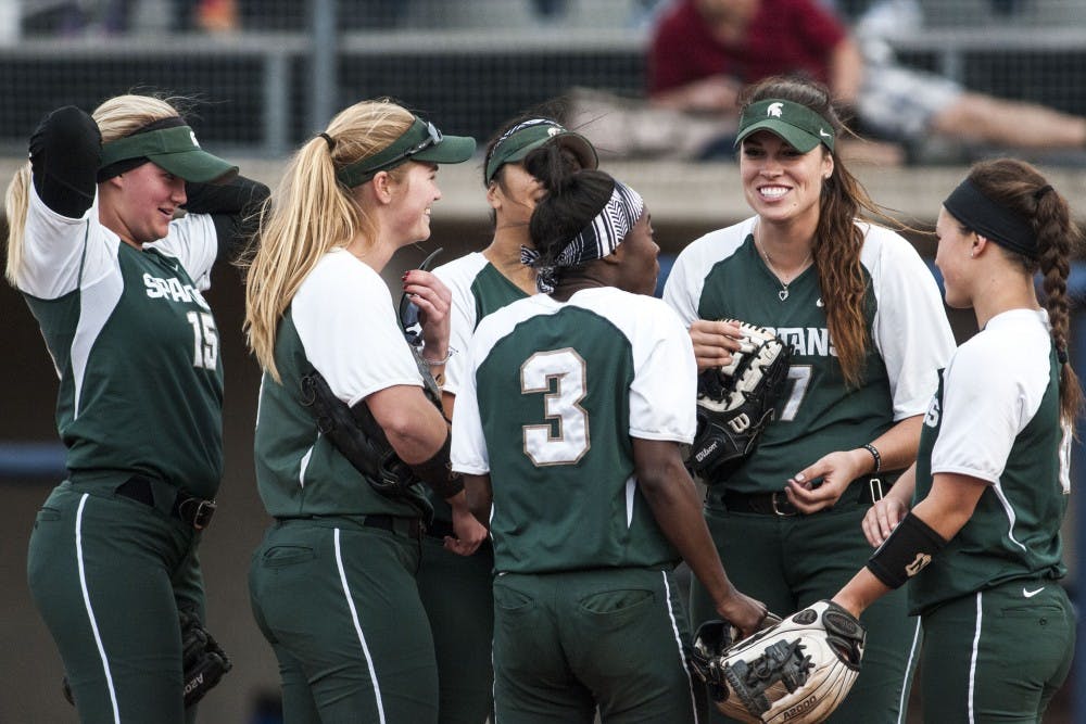 <p>Spartan teammates laugh during the game against University of Michigan on April 18, 2017 at Wilpon Baseball and Softball Complex in Ann Arbor. The Spartans were defeated by the Wolverines, 3-1.</p>