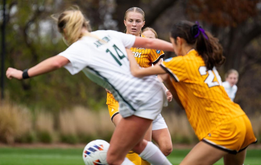 <p>Western Michigan University junior midfielder Madi Canada (14) keeps her eyes the ball during the NCAA soccer tournament game between MSU and WMU on Nov. 16, 2024. The Spartans defeated the Broncos, 3-1.</p>