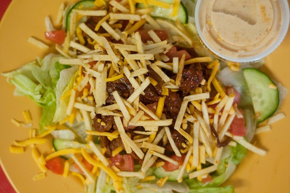 <p>A Smokehouse salad from BackYard Bar-B-Q on South Washington Square in Lansing. BackYard Bar-B-Q has two locations in downtown Lansing and Okemos and is known for their pulled pork. Hannah Levy/The State News</p>