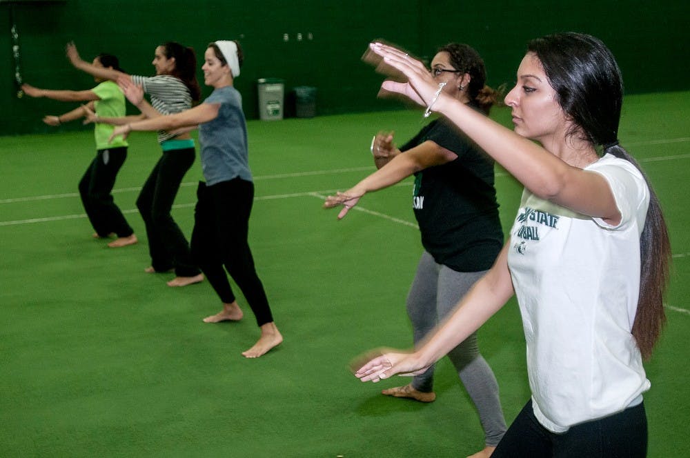 <p>MSU Bhangra dance member zoology freshman Akanksha Bawa, right, practices her dance routines with teammates on Oct. 1, 2014, at IM West. Bhangra is the traditional cultural dance of Punjab, India. The dance group competes nationally in Bhangra competitions every year. Raymond Williams/The State News</p>