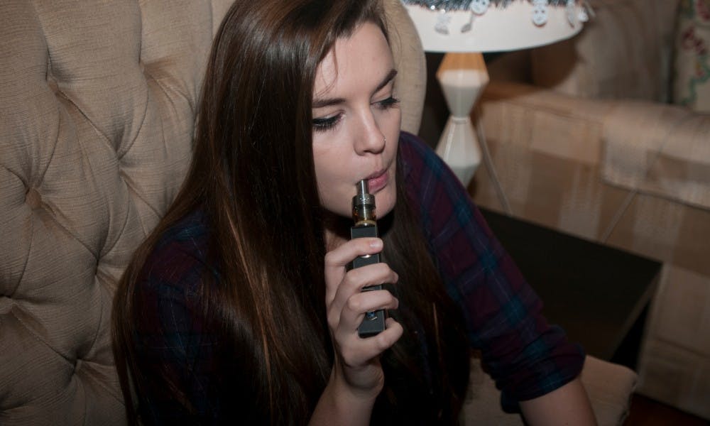 <p>Psychology sophomore Nicole Westerberg uses a vaporizer on Nov. 5, 2015 at her home in East Lansing. Westerberg said that she previously smoked cigarettes but decided to switch. </p>