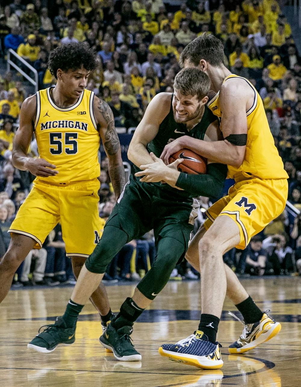 <p>Redshirt senior forward Kyle Ahrens (0) fights for a loose ball during the game against Michigan Feb. 8, 2020 at the Crisler Center. The Spartans fell to the Wolverines, 77-68.</p>