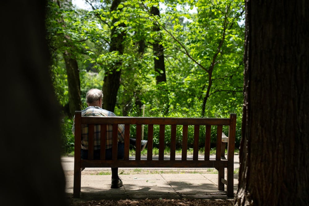 <p>A person sits on a bench in the W.J. Beal Botanical Garden in East Lansing, Mich., on June 28, 2026.</p>