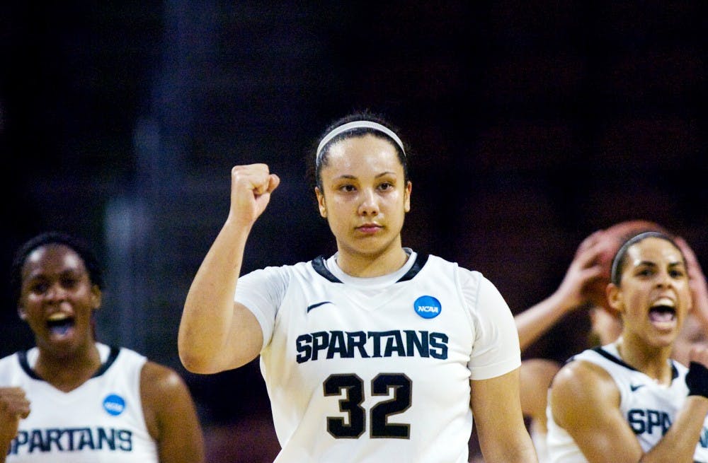 Senior forward Kalisha Keane, center, celebrates the teams win along with her teammates junior Lykendra Johnson, left, and Brittney Thomas, right, after the time expired in the NCAA Tournament first round game against Northern Iowa University on Sunday night at INTRUST Bank Arena in Wichita, Kansas. The Spartans defeated the Wildcats, 69-66, advancing them to the second round game on Tuesday. Lauren Wood/The State News