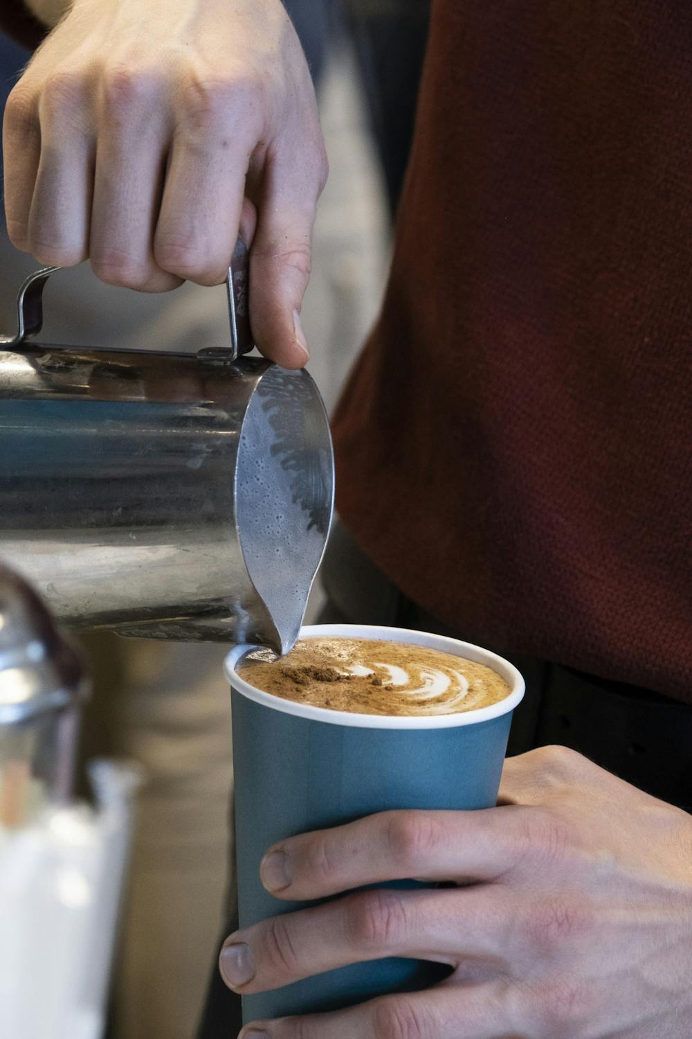 <p>An employee pouring coffee at Foster Coffee Company in East Lansing on Sept. 30, 2021. </p>