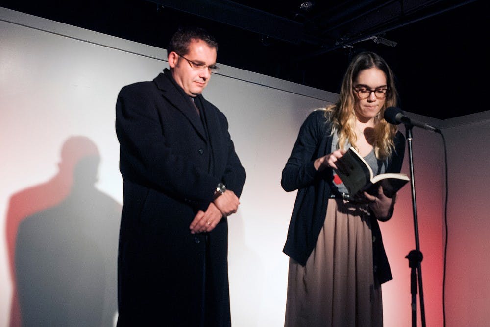 <p>MSU alumna Leila Chatti reads a poem in Arabic with her father Karim Chatti on March 13, 2014, at (SCENE) Metrospace. The father daughter duo read selections of several poems. Allison Brooks/The State News</p>