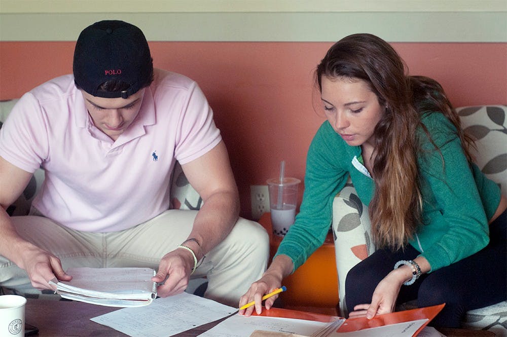 <p>Bella Dicarlo and Tommy Quin of East Lansing study together after class at Bubble Island, 515 E Grand River Ave, East Lansing, MI 48823. Dicarlo says when she needs the extra tutoring, Quin assists her. 
Asha Johnson/The State News </p>