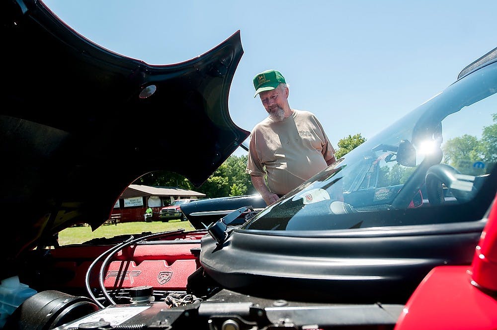 	<p>Woodland, Mich., resident Barry Donaldson looks at a 1993 Dodge Viper July 13, 2013, at the 24th Annual Ledges Classic Auto Show at Fitzgerald park, 133 Fitzgerald Park Dr. in Grand Ledge. The Viper&#8217;s top speed is 180 miles per hour.Weston Brooks/The State News</p>