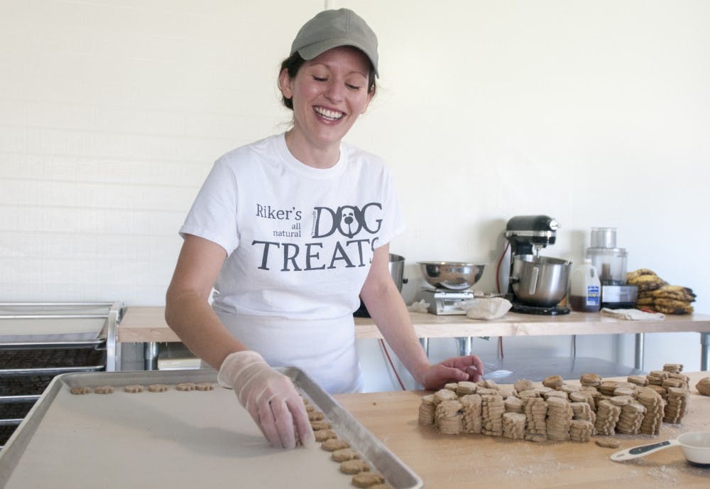 Bath resident Leslie Cowell expresses emotion as she sets the dog treats on a tray to prepare for cooking in the oven on Feb. 13, 2017 in her home that doubles as Riker's Dog Treats HQ and bakery in Bath, Michigan. Riker's Dog Treats is owned by Cowell and her husband, Adam Cowell.