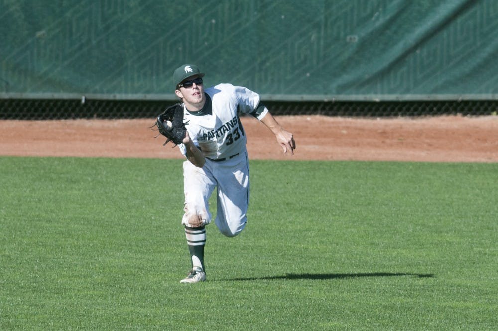 <p>Sophomore outfielder Brandon Hughes catches a fly ball during the baseball exhibition game against Air Force  on Sept. 19, 2015 at McLane Stadium. MSU baseball season begins in February. Jack Stephan/The State News</p>