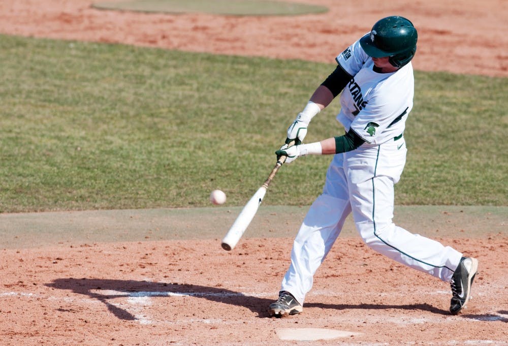 Sophomore third baseman Torsten Boss hits the ball, but ended up grounding out on the play. The Spartans lost to Central Michigan, 3-1, on Wednesday at McLane Stadium at Kobb Field. Josh Radtke/The State News