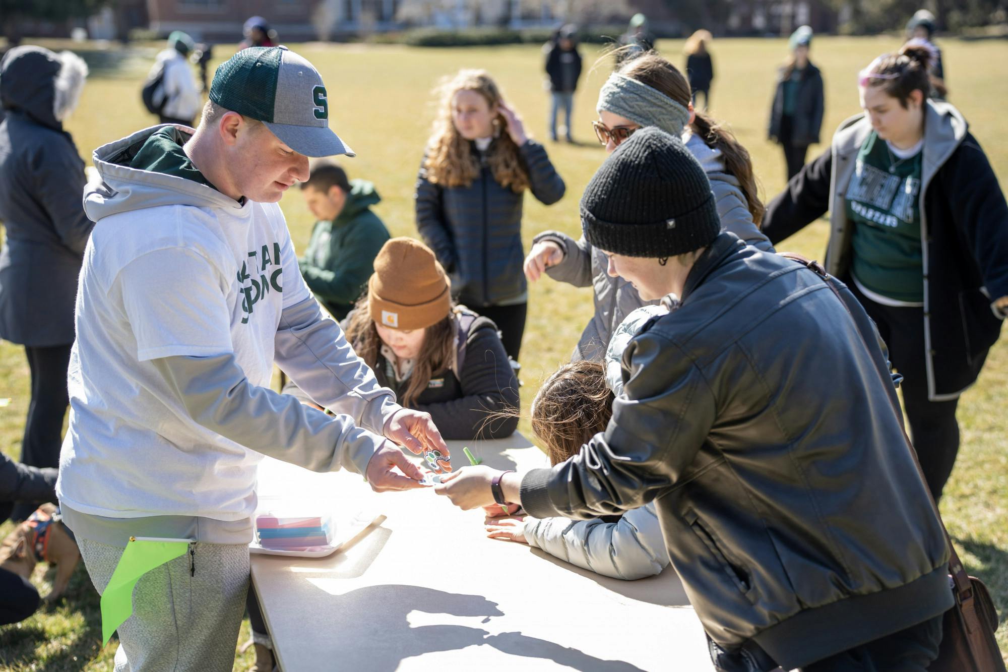 <p>Students fill out notecards at Demonstration Field, participating in the walkout on March 19, 2023.</p>