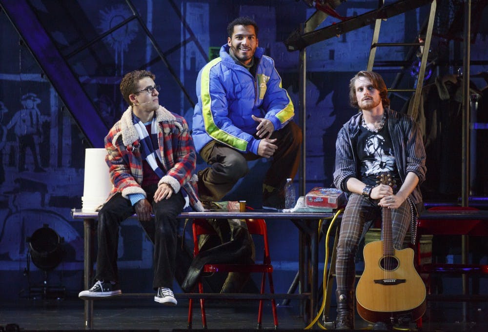 <p>Christian Thompson, center, sings in RENT. Photo courtesy of the Wharton Center.</p>