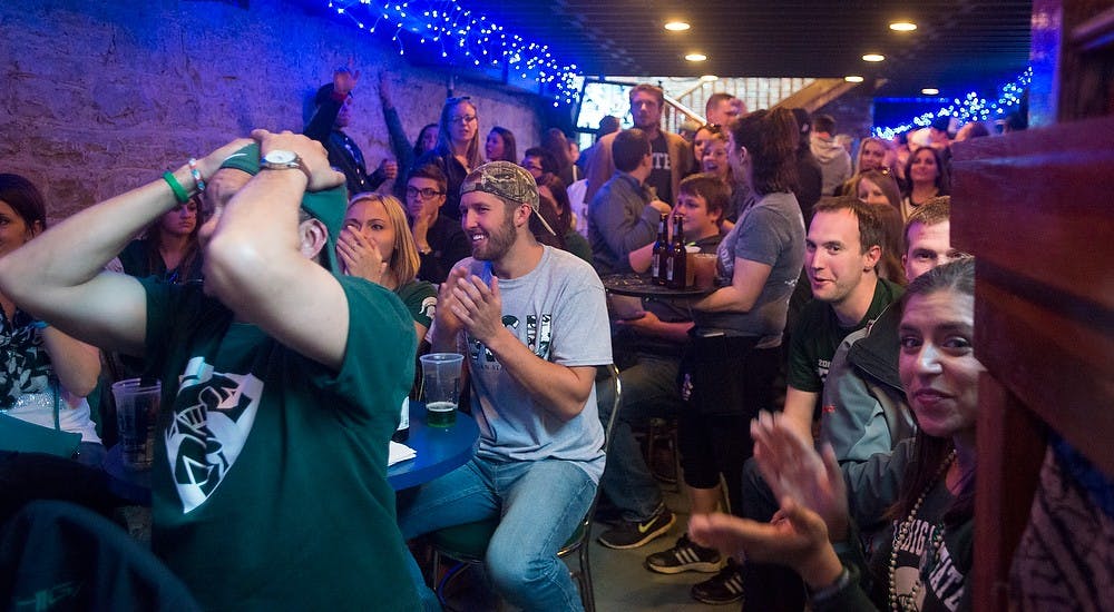 <p>Spartan fans react to a play April 4, 2015, during the semi-final game of the NCAA Tournament in the Final Four round at Slippery Noodle Inn in Indianapolis, Indiana. The Slippery Noodle Inn is Indiana's oldest bar and welcomes spartans. Hannah Levy/The State News</p>