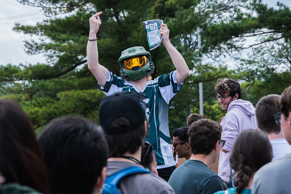 Advertising Creative junior Tommy Wehr holds a sign for E-Sports at Sparticipation on Aug. 31, 2021. The event was held in-person at Cherry Lane Park, after being forced to move online in 2020.
