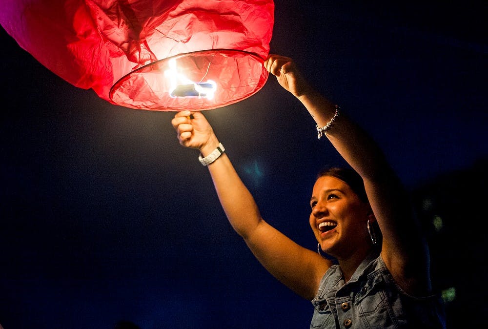 	<p>Lansing resident Mercedes Villarreal tries to release a sky lantern, July 4, 2013, at Adado Riverfront Park. &#8220;We tried to do one firework that isn&#8217;t dangerous,&#8221; Villarreal said. Justin Wan/The State News</p>