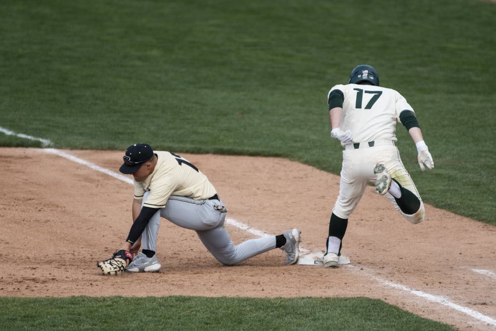 Senior outfielder Bryce Kelley (17) running into first base during the game against Purdue on April 11, 2021, at the McLane Stadium. The Spartans defeated the Boilermakers 5-2.