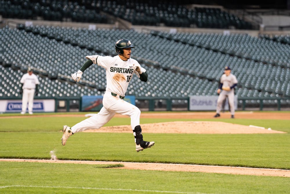 <p>Redshirt senior Peter Ahn (16) races to first base during the Spartans&#x27; matchup against Notre Dame at Comerica Park in Detroit on April 26, 2022.</p>