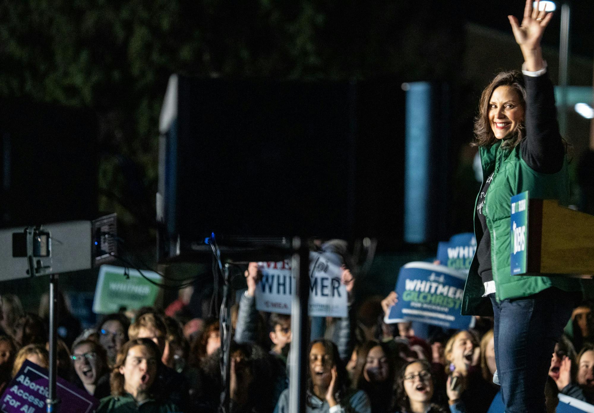 Gov. Gretchen Whitmer smiles and waves to the crowd while they cheer for her at the Democratic GOTV Grand Finale Rally at MSU's Auditorium Field on Nov. 7, 2022. 