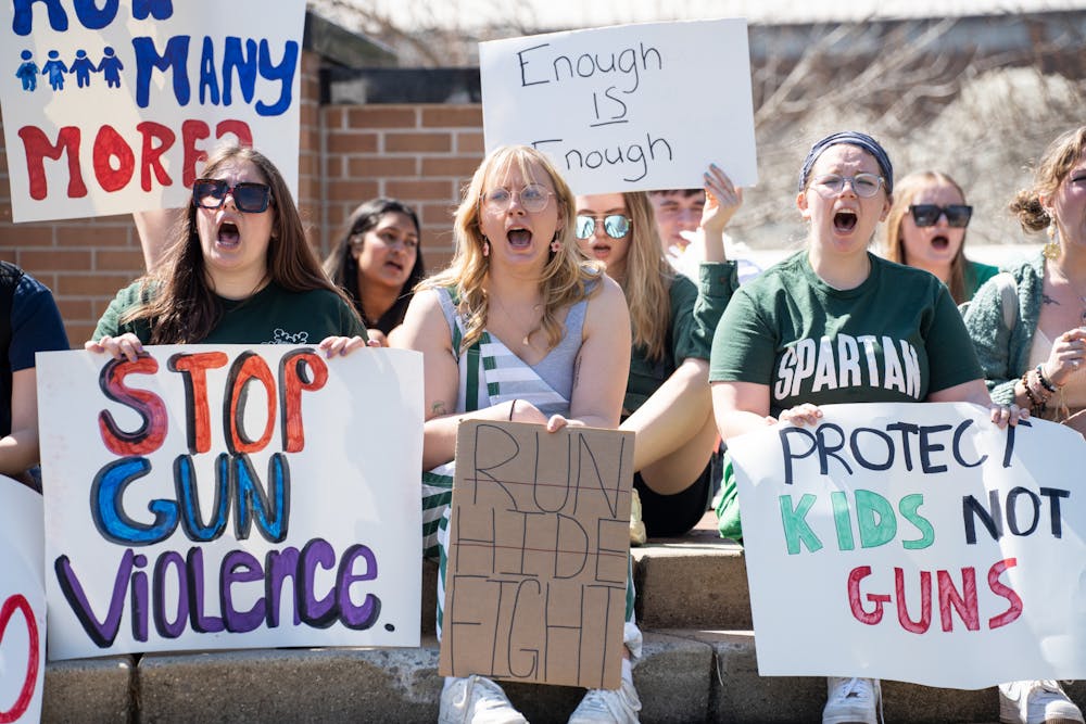 <p>ASMSU president Jo Kovach and fellow MSU students protest against gun violence at the Spartan Statue on April 12, 2023. They walked from Berkey Hall to the Spartan Statue chanting the victims' names who died to gun violence.</p>