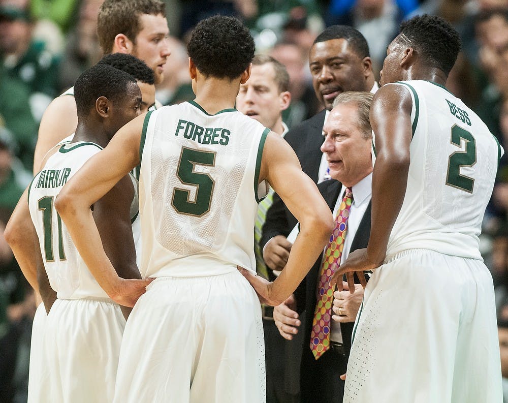 <p>Head coach Tom Izzo strategizes with his players Dec. 20, 2014, during the game against Texas Southern at Breslin Center. The Spartans were defeated by the Tigers, 71-64. Erin Hampton/The State News</p>