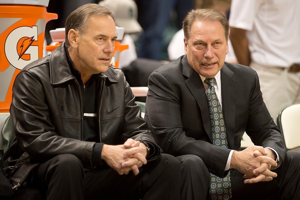 <p>Football head coach Mark Dantonio, left, and head coach Tom Izzo talk before the game against Michigan on Jan. 25, 2014, at Breslin Center. The Spartans lost to the Wolverines, 80-75. Julia Nagy/The State News</p>