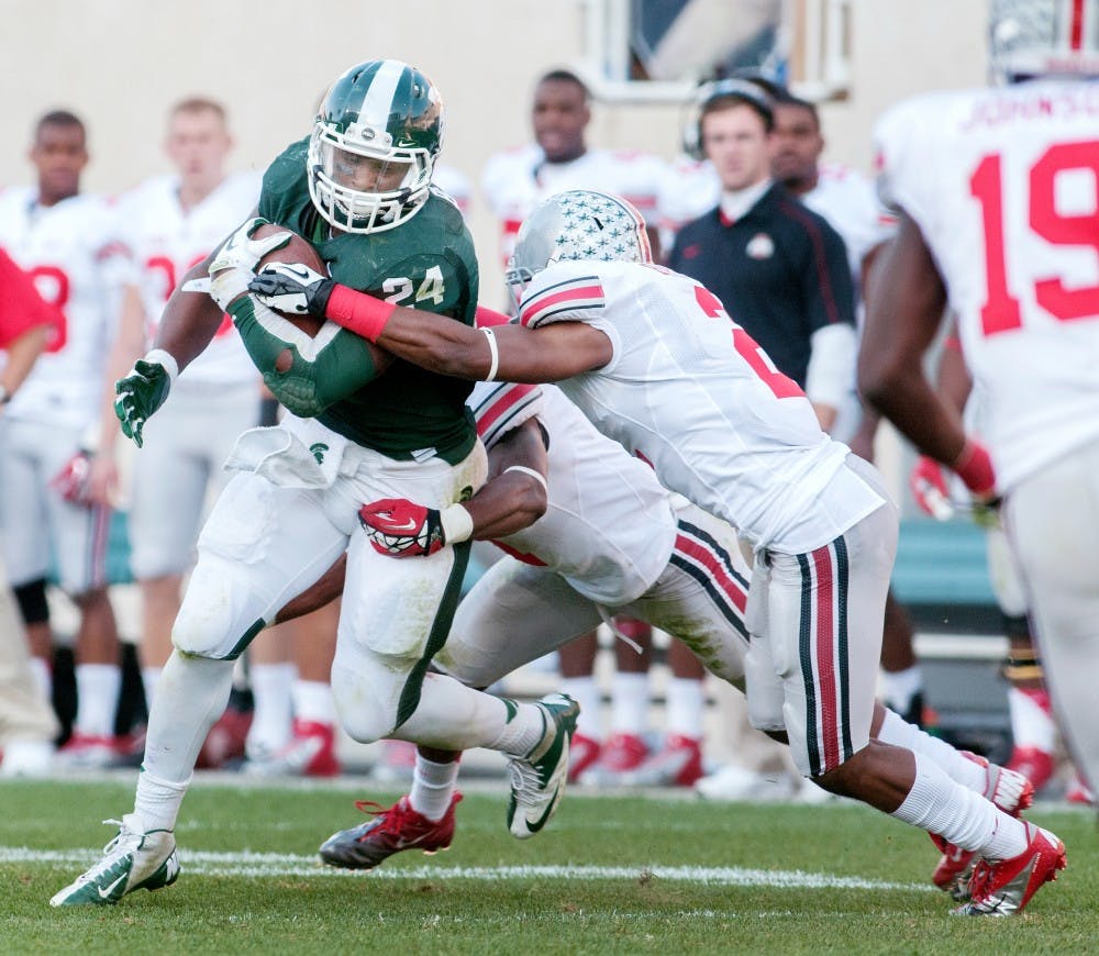 	<p>Ohio State defenders attempt to take down junior running back Le’Veon Bell during the <span class="caps">MSU</span> vs. Ohio State game on Sept. 29 at Spartan Stadium. Bell recorded 47 rushing yards during the game. Natalie Kolb/The State News</p>