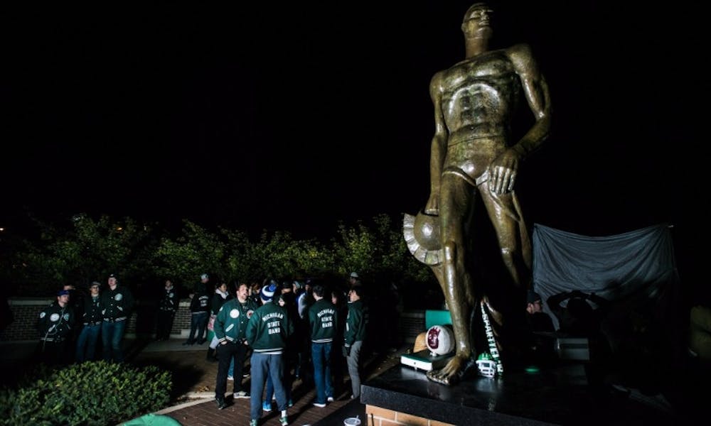Members of the Spartan Marching Band stand and talk during the annual week of Sparty Watch on Oct. 25, 2016 at the Spartan Statue. Photo: Carly Geraci