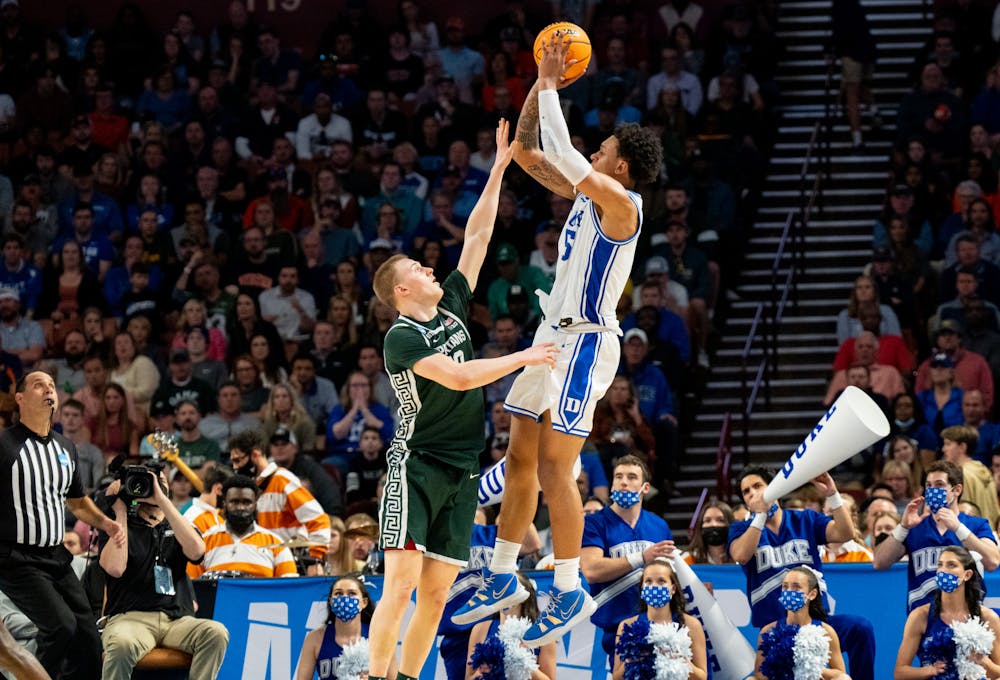 <p>Freshman forward Paolo Banchero (5) shoots the ball as redshirt senior forward Joey Hauser (10) attempts to block during Duke&#x27;s victory over Michigan State on March 20, 2022.</p>