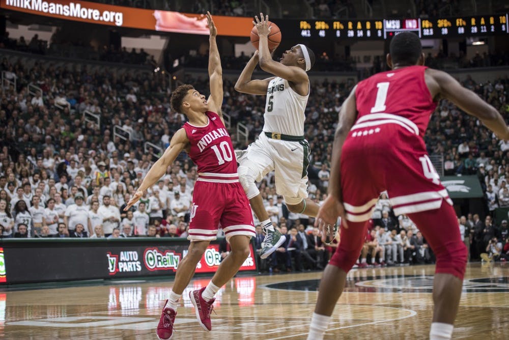 Junior guard Cassius Winston (5) shoots over Indiana guard Rob Phinisee (10) during the men's basketball game against Indiana on Feb. 2, 2019 at Breslin Center. Michigan State lost to Indiana in overtime 79-75. Nic Antaya/The State News