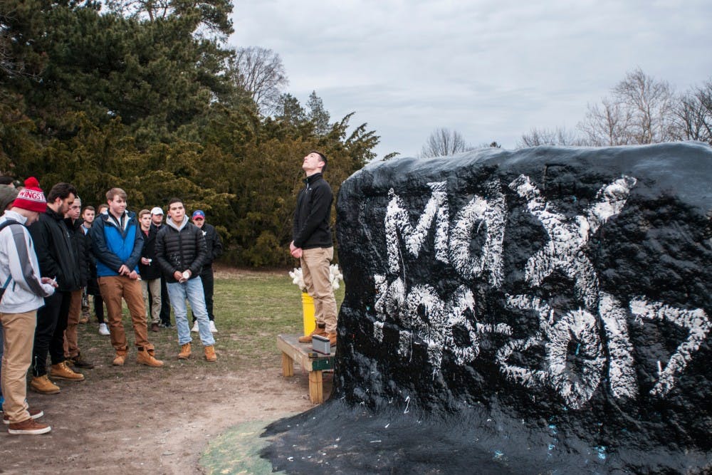 Kinesiology sophomore Danny Morehouse, center, looks to the sky as he talks during Lambda Chi Alpha's candlelight vigil honoring the life of Max Muessig on March 23, 2017 at the Rock on Farm Lane. Political science and economics sophomore Max Muessig died over spring break when a tree fell on his car because of heavy winds. 