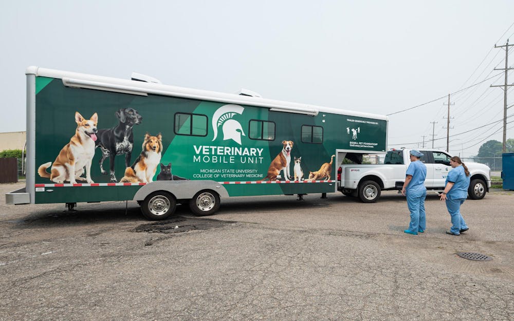 <p>The MSU Veterinary Mobile Unit team help each other guide the trailer out of the parking lot in Warren, Mich., on July 16, 2026.</p>