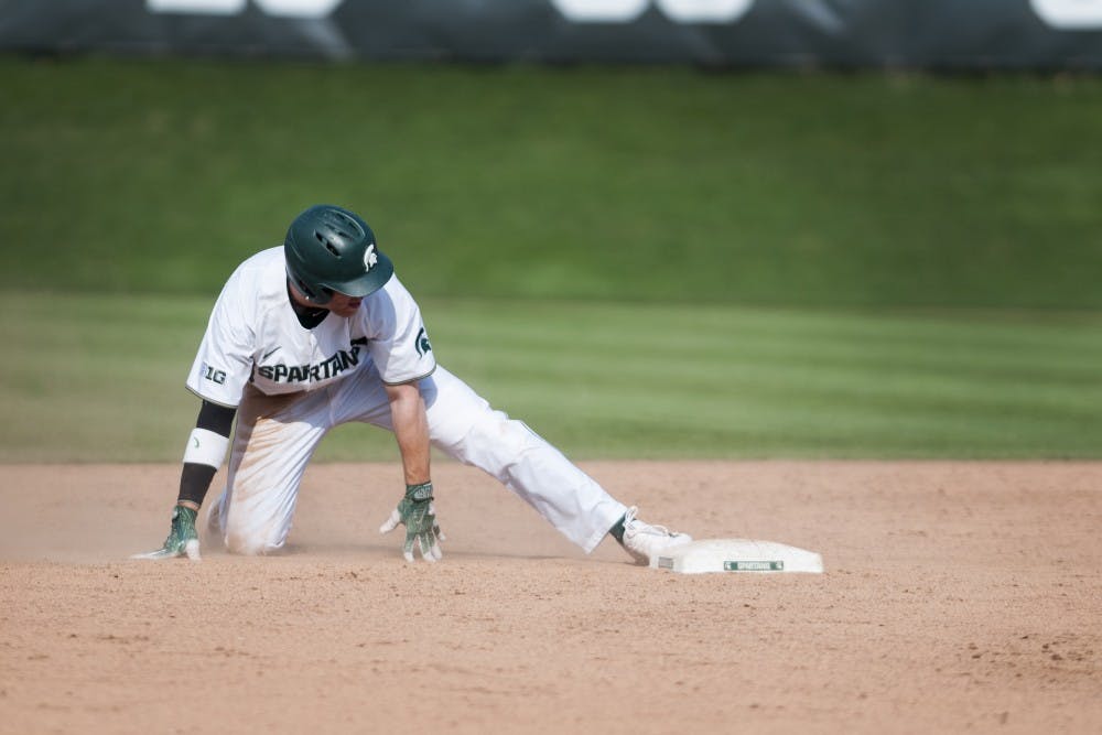 <p>Junior outfielder Brandon Hughes (33) touches second base with his foot during the game against Toledo on April 26, 2017 at McLane Baseball Stadium at Kobs field. The Spartans defeated the Titans, 11-1.&nbsp;</p>