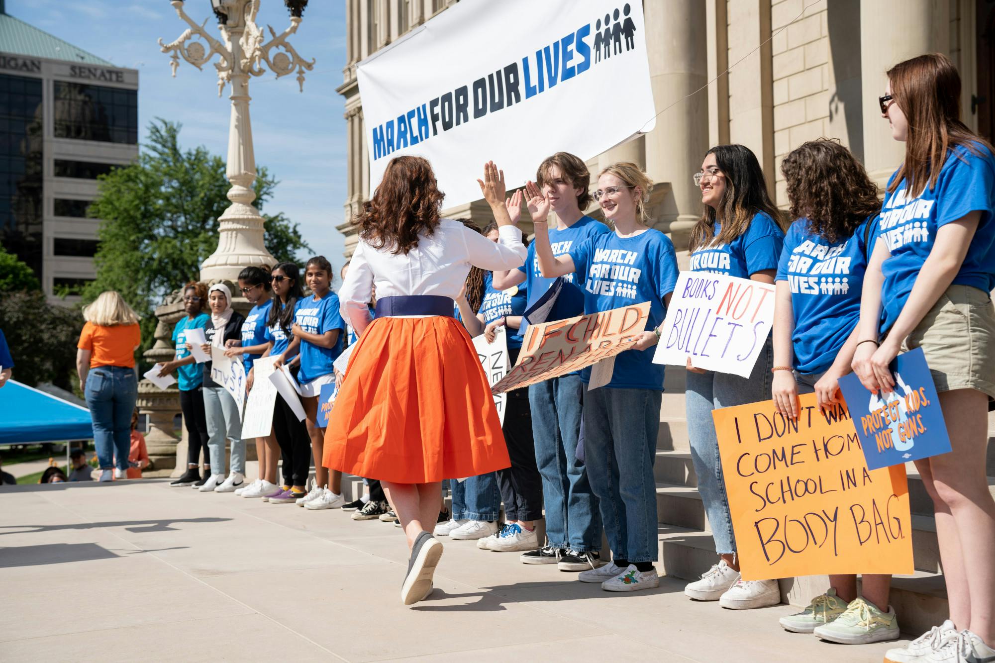 <p>Gov. Gretchen Whitmer high-fives students who gathered outside the Michigan State Capitol for the &#x27;March For Our Lives&#x27; rally for gun control on June 11, 2022.</p>