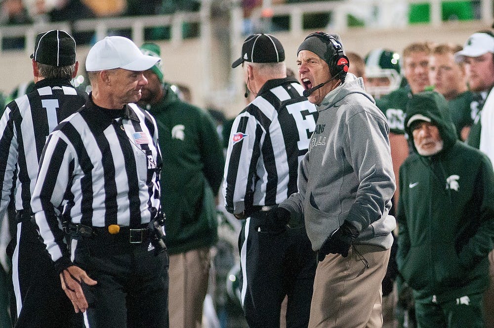 <p>Head coach Mark Dantonio yells at the referee after a pass interference call was made Oct. 4, 2014. during the game against Nebraska at Spartan Stadium. The Spartans defeated the Cornhuskers, 27-22. Erin Hampton/The State News</p>