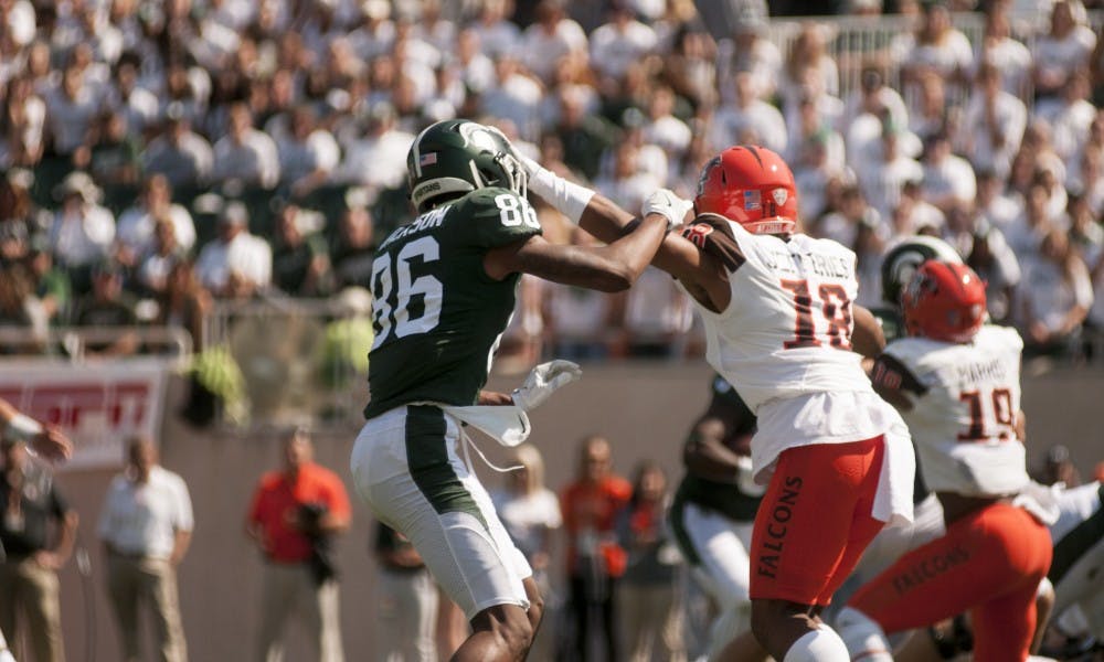 Sophomore wide receiver Trishton Jackson (86) is blocked by Bowling Green defensive back Cameron Jefferies (18) during the game against Bowling Green on Sep. 2, 2017, at Spartan Stadium. The Spartans defeated the Falcons, 35-10.