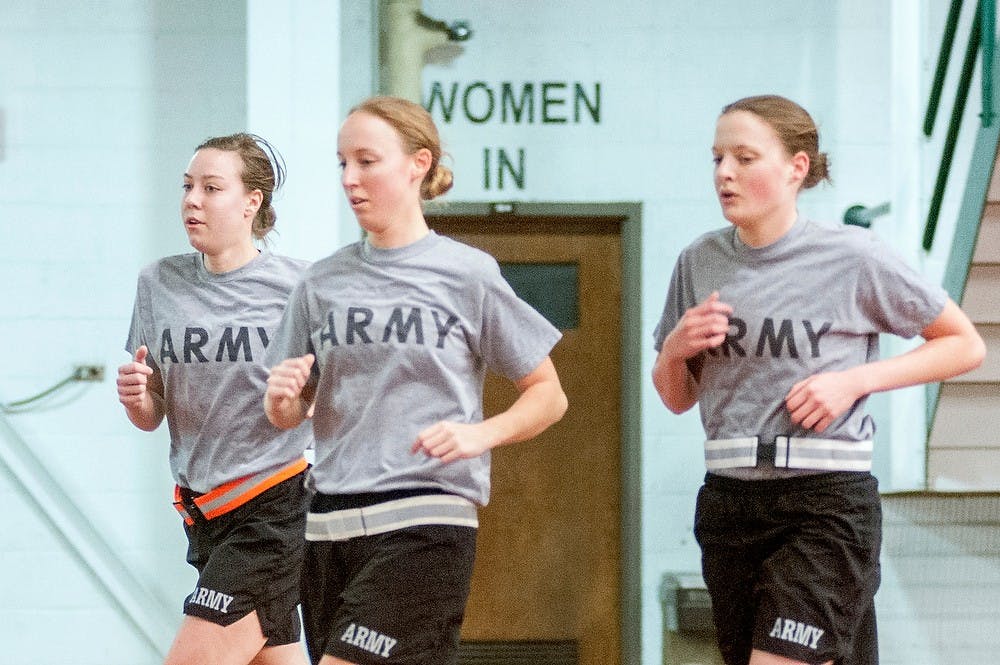 	<p>From left, physiology junior Gigi Schade, nursing senior Teresa Kuyers, and human biology senior Melissa Branderhorst run laps inside Jenison Field House as part of their physical training, Thursday, Jan. 24, 2013.  Defense Secretary Leon Panetta announced lifting a band Thursday to allow women to be in combat positions. Justin Wan/The State News</p>