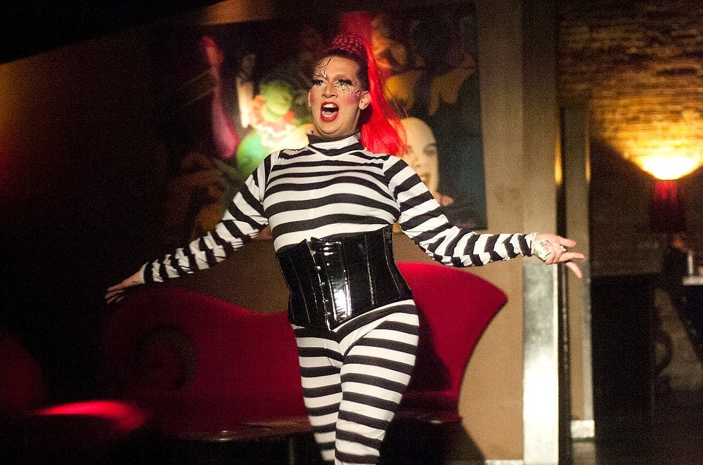 <p>Drag queen Ace DeVille walks out as the first performer during Showbiz Sunday on March 30, 2014, at Spiral Video & Dance Bar. DeVille began performing as a circus clown when she was nine years old. Emily Jenks/The State News</p>