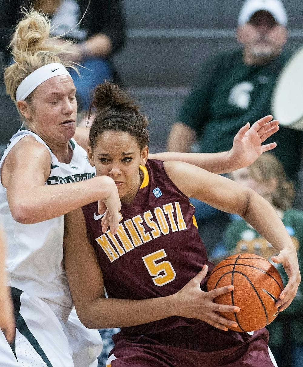 	<p>Minnesota guard/forward Kionna Kellogg runs into senior forward Courtney Schiffauer as Schiffauer plays defense. The Spartans defeated the Gophers, 66-51, Thursday, Jan. 3, 2012, at Breslin Center. Justin Wan/The State News</p>