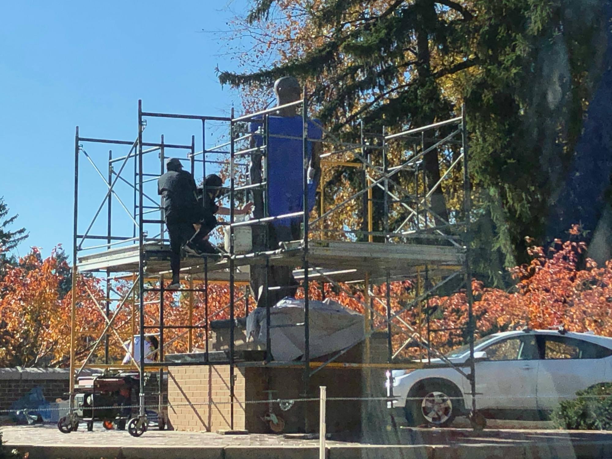 <p>Young Joon Kwak, the artist-in-residence for the MSU Art, Art History and Design Department, takes molds of the Sparty statue with their assistants, which they will use to create separate sculptures to be displayed on March 25, 2021, at the MSU Union.</p>