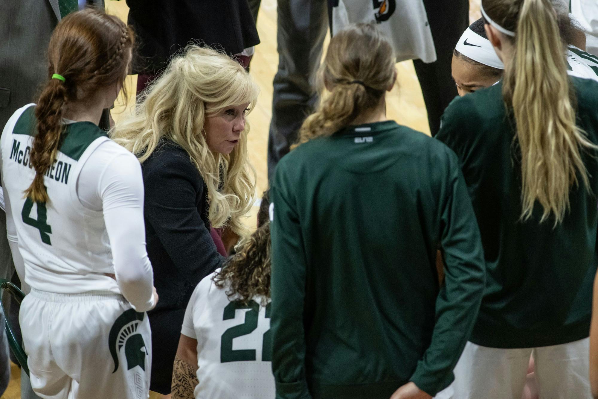 <p>Head Coach Suzy Merchant talks in a huddle during the game against Northwestern on Jan. 23, 2020 at the Breslin Center. The Spartans fell to the Wildcats, 76-48.</p>