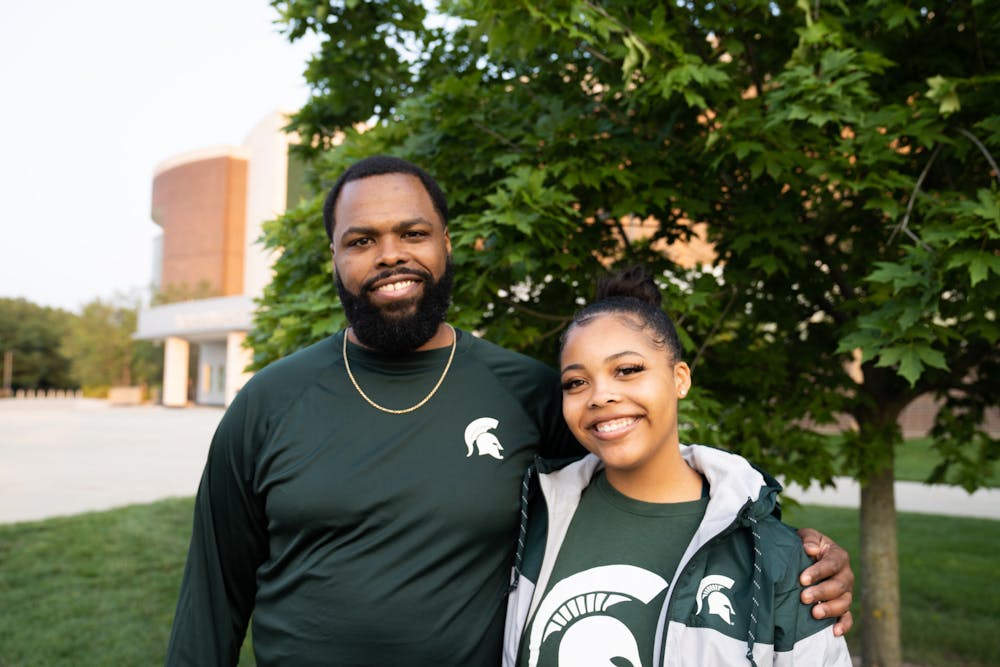 Freshman Kinesiology major Trayshawn Holbrook and her father Rayshawn Holbrook stand outside of Breslin Center on Sept. 14, 2022. Trayshawn said her time at Breslin Center when she was young, watching the school spirit and women empowerment during games, was one of the reasons she chose MSU. 