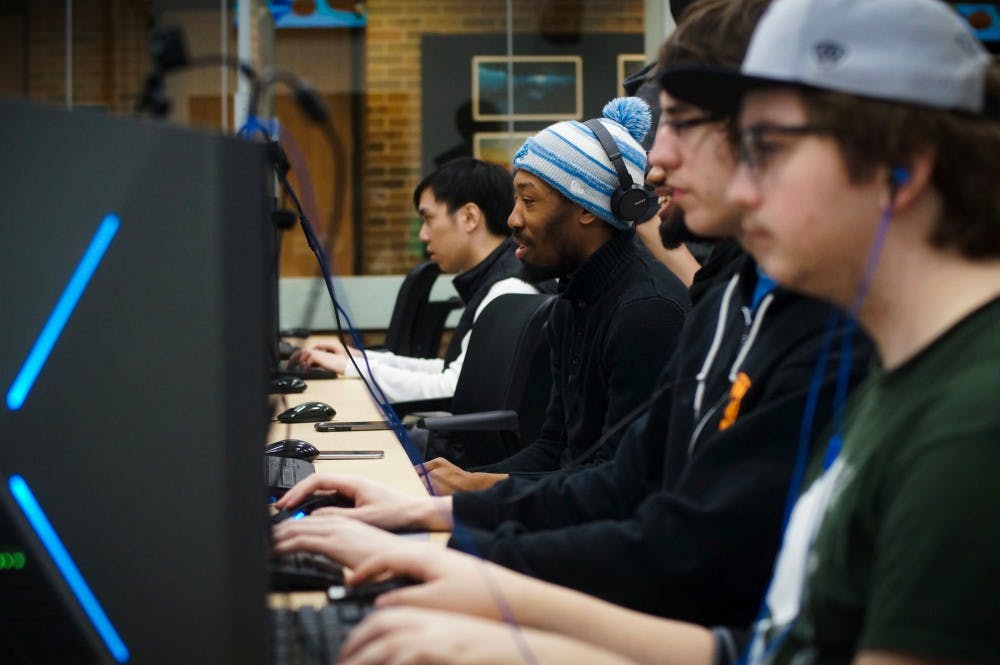 Computer science junior Nicholas Gilreath, center, plays a video game on Feb.18, 2017 at Communication Arts and Sciences Building. The LAN event allows students to play offline and play by connecting their consoles or computer with each other. The LAN events goal is to bring together esports players within the MSU community. 