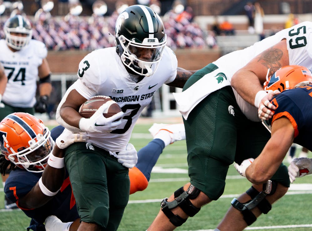 5th year running back Jarek Broussard (3) pushes past University of Illinois during a game at Memorial Stadium on Nov. 5, 2022. Spartans beat the Fighting Illini with a score of 23-15. 
