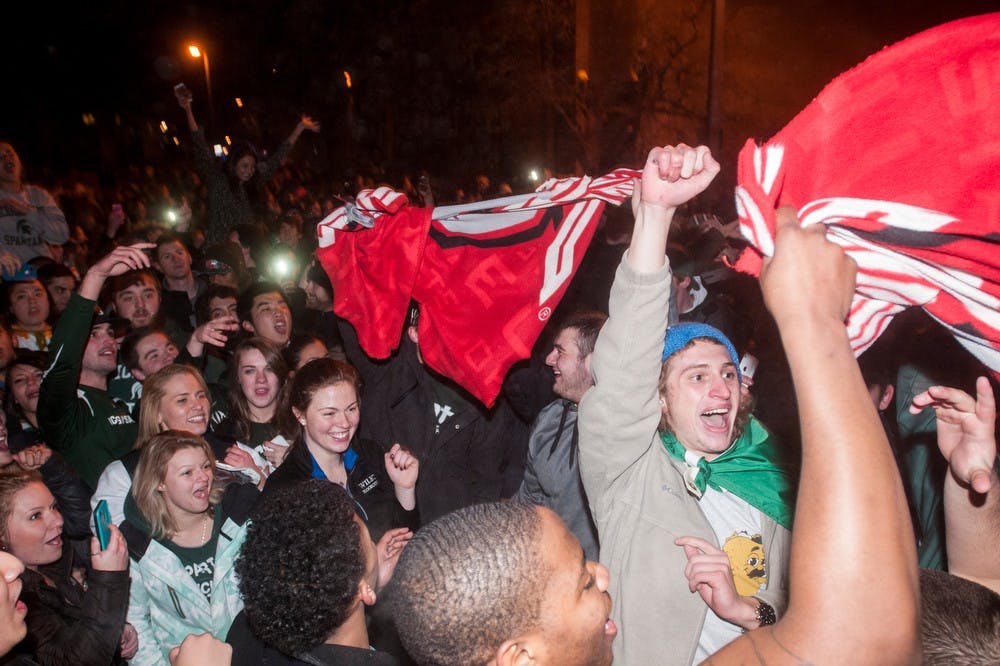	<p>Students tear apart an Ohio State flag in the streets of Cedar Village after an <span class="caps">MSU</span> victory in the Big Ten Championship game on Dec. 8, 2013. The police and fire department responded to multiple fires across East Lansing.</p>