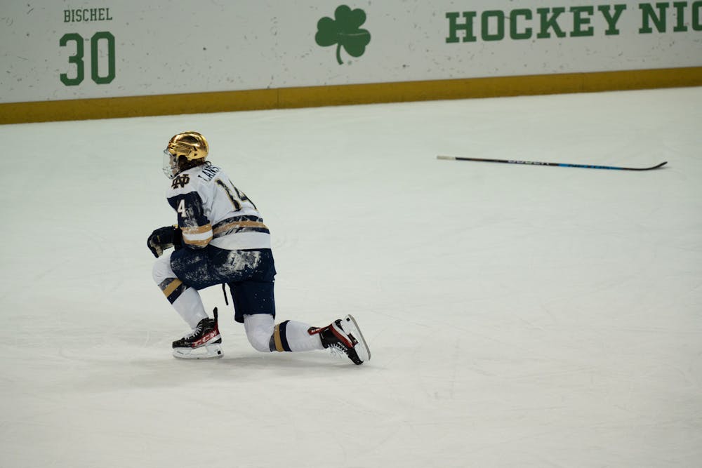 <p>Notre Dame winger Jesse Lansdell slowly rises and heads to the bench after losing his stick in a yard-sale hit at Compton Family Ice Arena in Notre Dame, IN on Friday, March 4, 2023. Lansdell recorded 3 shots and 2 blocks during the game.</p>