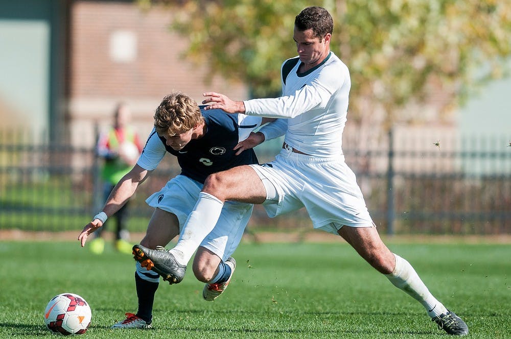 	<p>Junior forward Adam Montague and Penn State midfielder Grant Warming fight for the ball during the game against Penn State on Oct. 20, 2013, at DeMartin Soccer Stadium. The Spartans fell to the Nittany Lions in double overtime, 1-2. Khoa Nguyen/The State News</p>