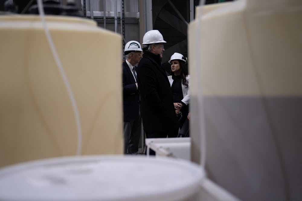 <p>University administrators chat in MSU's Simon Power Plant at a media event on March 20th, 2023.</p>