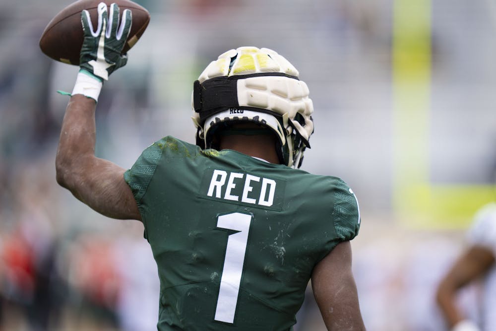 <p>Graduate wide receiver Jayden Reed (1) scores a touchdown in Michigan State Football’s return to Spartan Stadium with the spring game on Saturday, April 16, 2022.</p>